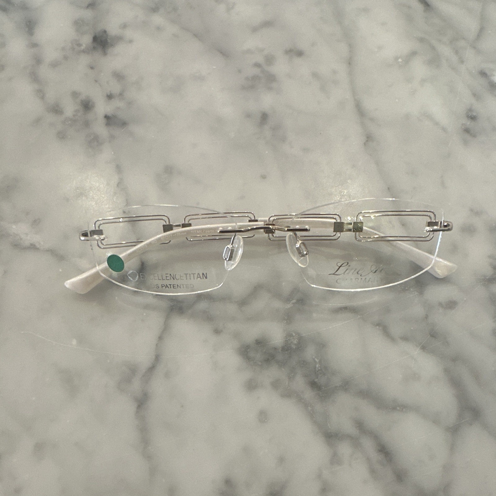 Line Art Charmant Rimless Frame. Black And Silver Retail$425